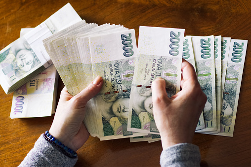 Mujer contando el dinero. Moneda Checa en billetes. photo