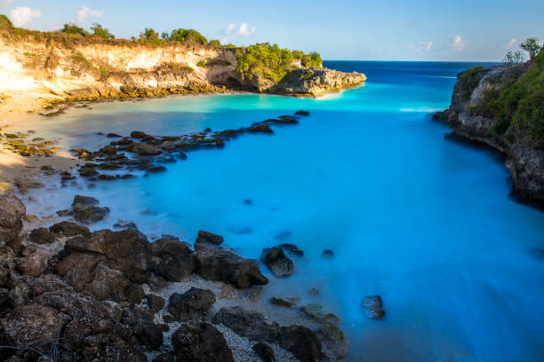 istock Crashing blue and white sea waves.Rocky Shore 1068764136