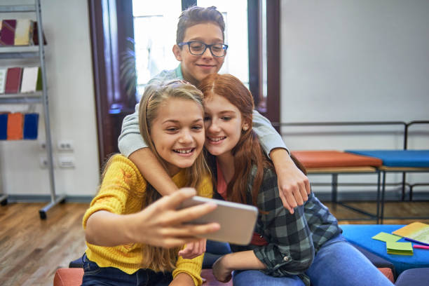 istock group of friends at school taking a selfie 1068776314