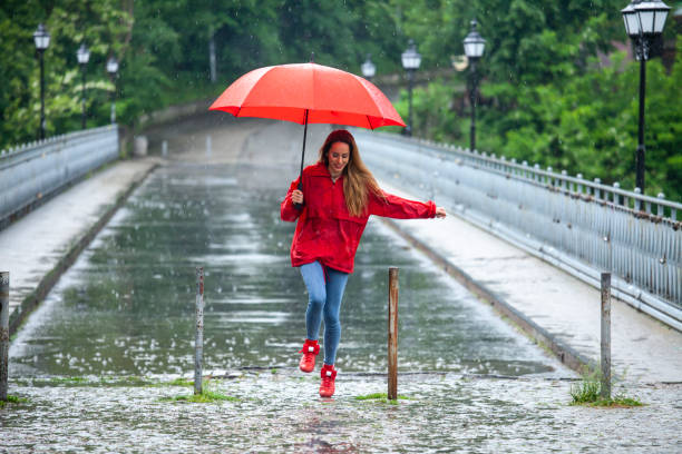 istock Beautiful girl with umbrella 1068778420