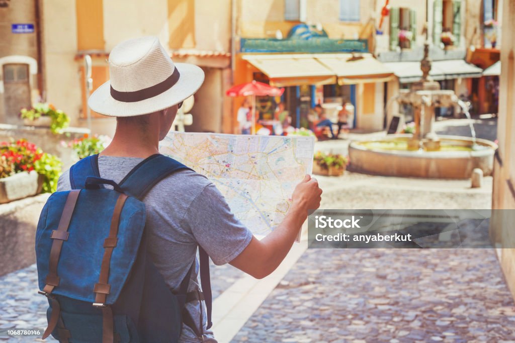 traveling people, tourist looking at map on the street in France, Europe traveling people, tourist looking at map on the street in France, Europe; travel concept Tourist Stock Photo