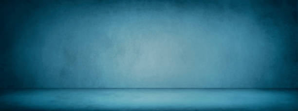 istock dark blue studio room banner and blank cement and concrete background 1068781098