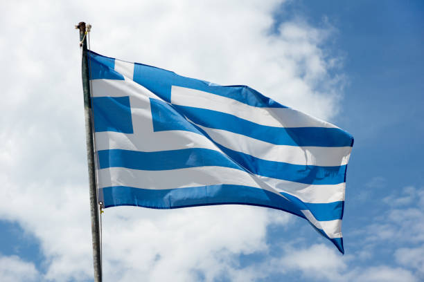 istock Waving Greece flag on skyscape background 1068785486