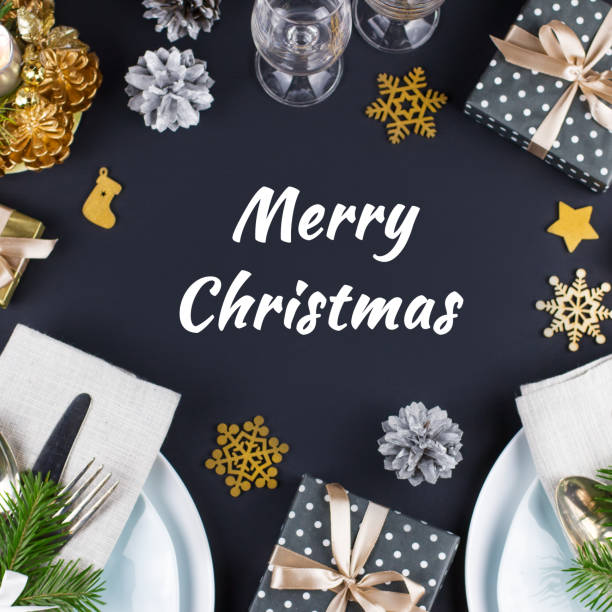 istock Merry Christmas greeting card with table setting with plates, silverware, presents and decorations in black and gold 1068793988
