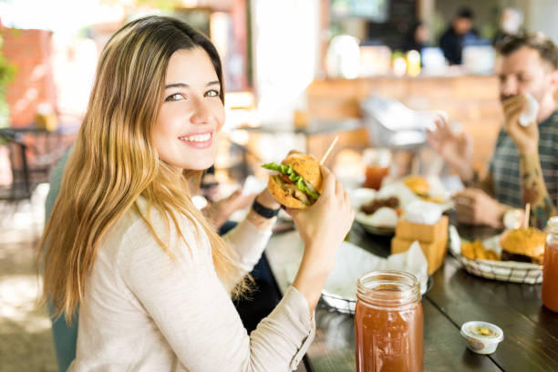 istock Cheerful Woman Holding Junk Food 1068794182