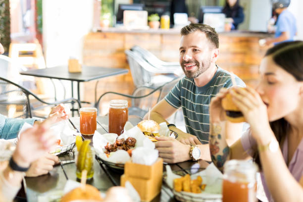 istock Friends Having Fast Food At Eatery 1068794858