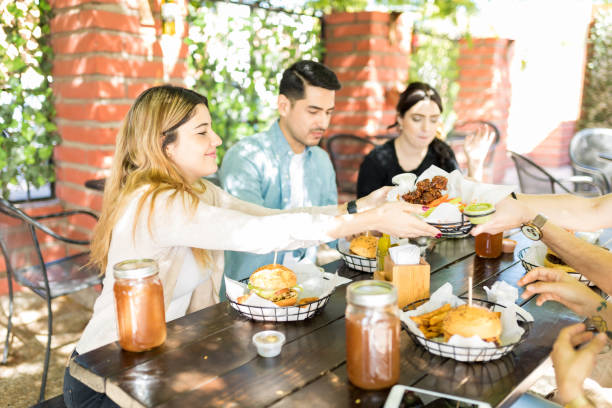 istock Friends Sharing Food During Reunion Party 1068795018