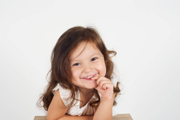 Little cute girl is laughing and looking at camera.
