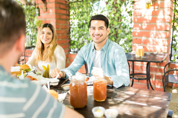 istock Man Celebrating Reunion With Friends At Restaurant 1068797488
