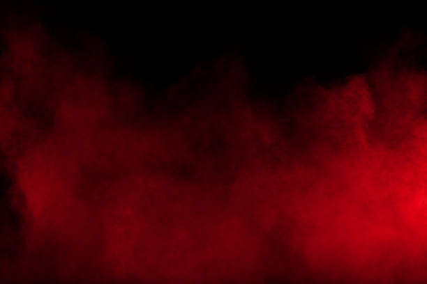 istock Red powder explosion on black background. Freeze motion of red dust particles splash on dark background. 1068797780