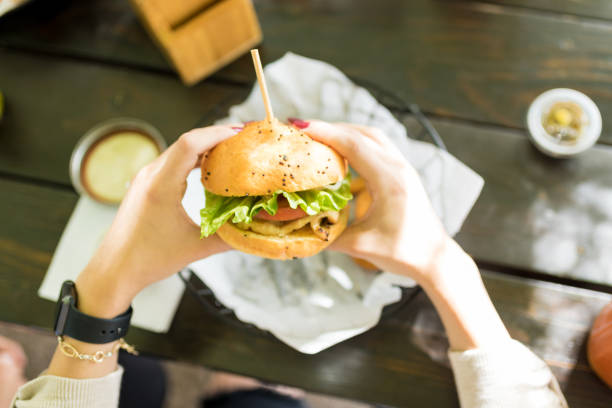 istock Overhead View Of Hands With Sandwich 1068798086