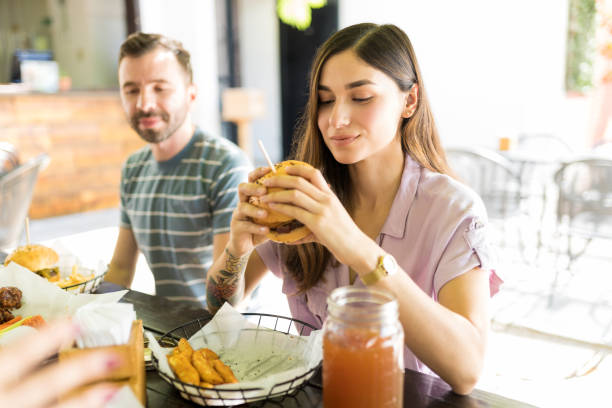 istock Woman Tempted To Have Yummy Burger 1068798846