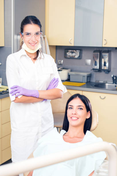 istock Young woman patient and dentist 1068802520