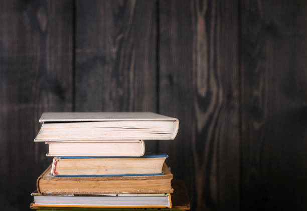istock Stack of hardback books on wooden table. Back to school. Copy space for text 1068807548