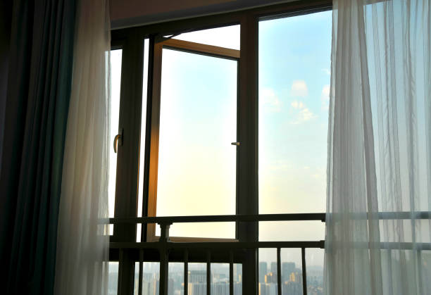 istock Curtain and window in sunrise background 1068808104