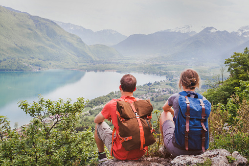 travel, two hikers enjoying beautiful panoramic mountain view, summer hiking