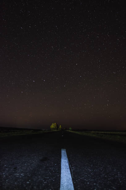 istock The road at night under the starry sky 1068811906