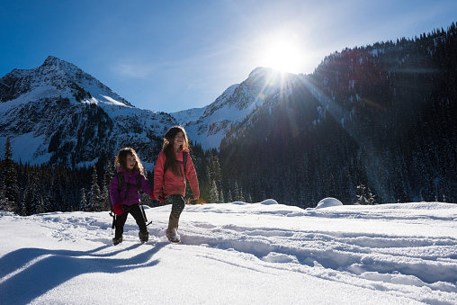 Young girls hiking to go winter camping