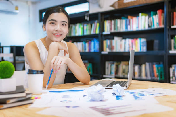istock Business woman thinking ideas strategy for new project at office desk. Teamwork successful Workplace strategy Concept. 1068817654