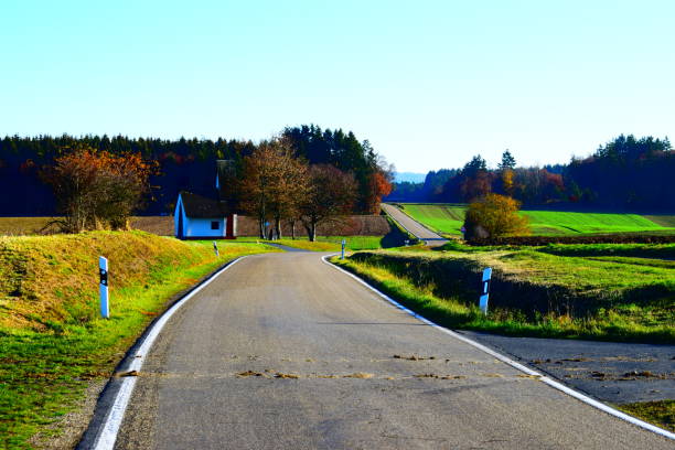 istock autumn road on green Eifel hills 1068821310