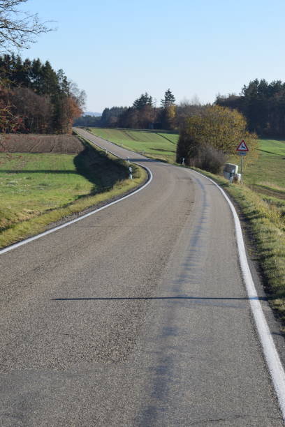 istock autumn road on green Eifel hills 1068822064