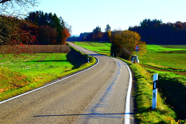 istock autumn road on green Eifel hills 1068822124