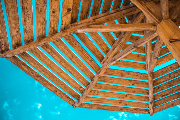istock an umbrella of natural materials on a blue sky with clouds 1068828236