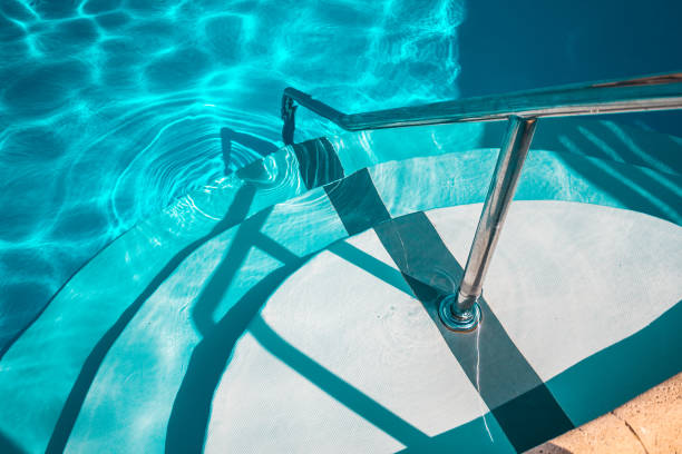 istock Swimming pool with white stairs in the hotel. 1068828436