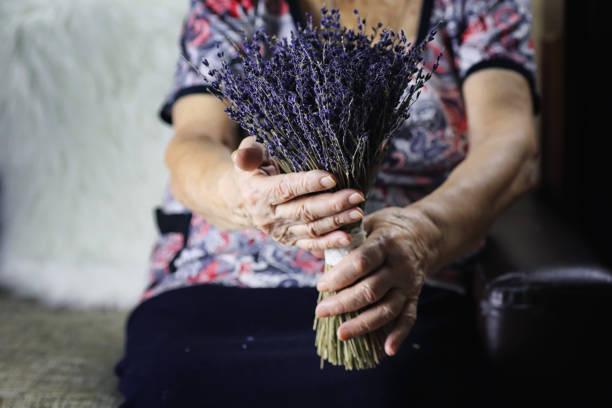 istock elder woman holding bouquet 1068828684