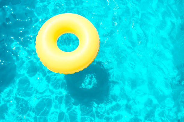 istock Inflatable ring swimming in the pool on a sunny day. 1068829012