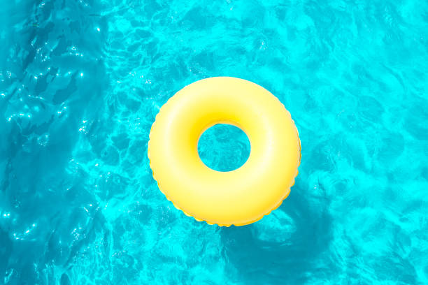 istock Inflatable ring swimming in the pool on a sunny day. 1068829020