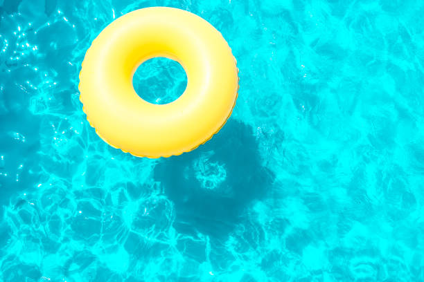 istock Inflatable ring swimming in the pool on a sunny day. 1068829228