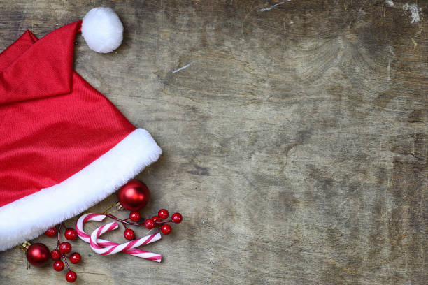 istock red santa hat on textured wooden background 1068829372