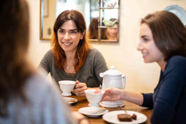 istock Mature Brazilian woman drinking coffee with daughters 1068831046