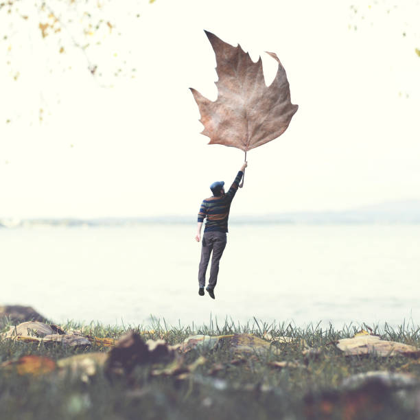 man flying with a leaf, autumnal surreal concept