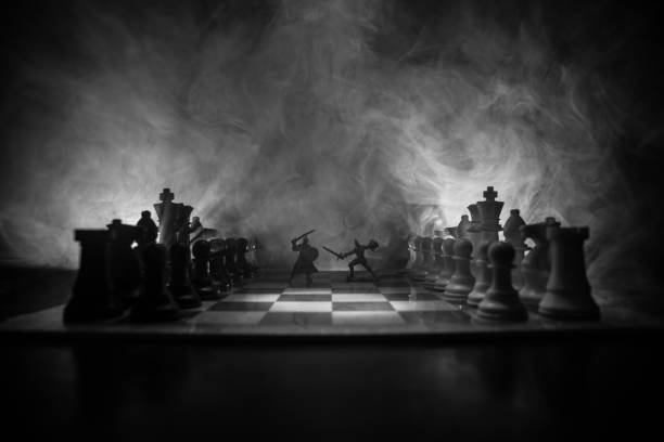 Medieval battle scene with cavalry and infantry on chessboard. Chess board game concept of business ideas and competition and strategy ideas Chess figures on a dark background with smoke and fog.