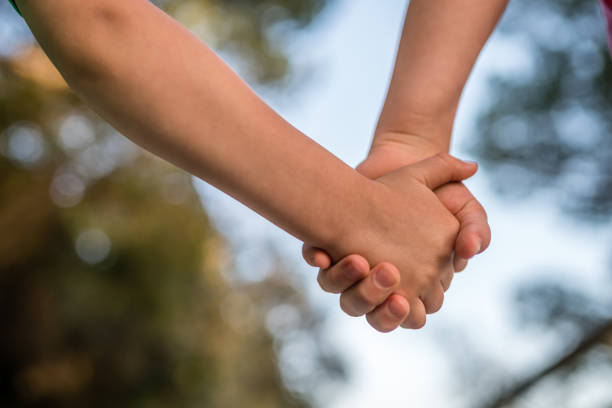 istock Kids holding hands together 1068838338
