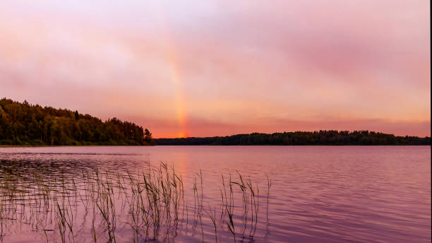 istock Rainbow over the lake at sunset 1068840676