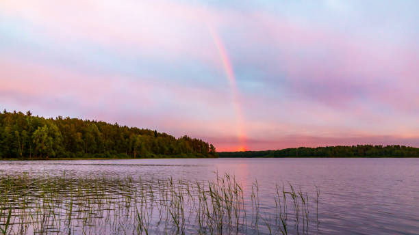 istock Rainbow over the lake at sunset 1068840686