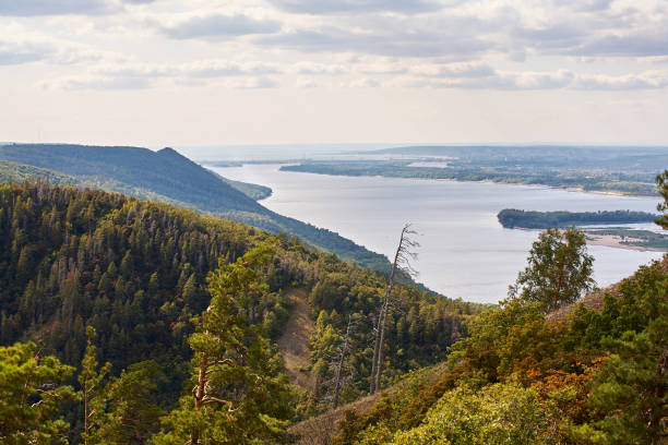 istock River against a cloudy sky with clouds and forest. 1068844502