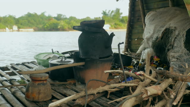 close up of an old fashioned kettle over traditional household cook-stove heated by charcoal in a houseboat