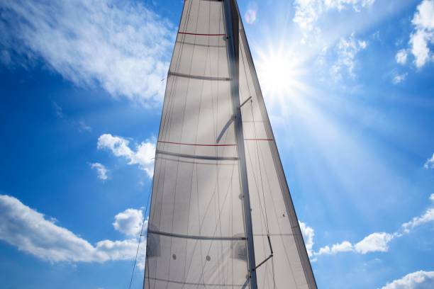 istock mast with sails and sun at noon, closeup 1068848618