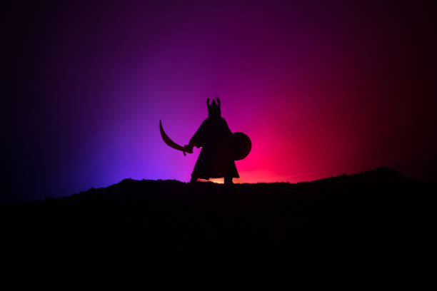 istock Fighter with a sword silhouette a sky. Medieval knight with sword. Selective focus 1068854290