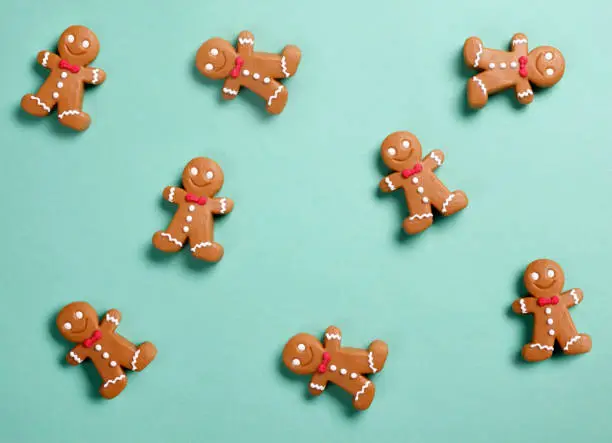 Gingerbread man cookies on green background.