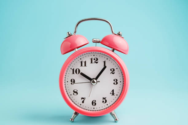 istock Red alarm clock on blue background 1068859674