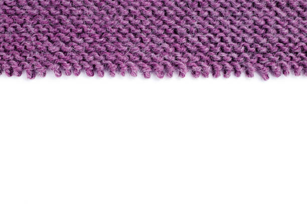 Unravelling knitted fabric on white background