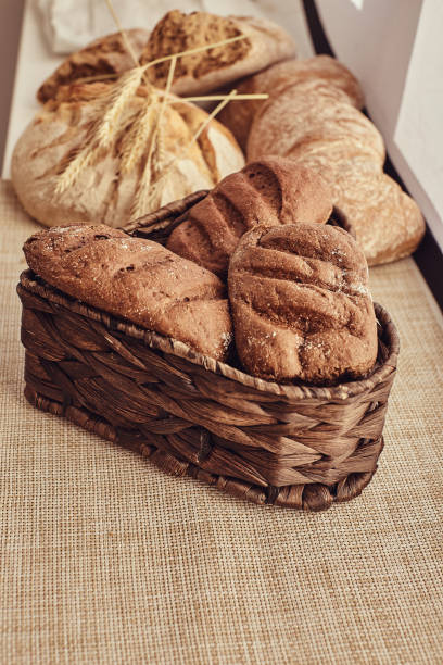 istock Freshly bakery products and spikelets on cloth at home. 1068859778