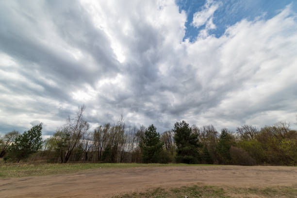 storm clouds forming over the countryside and fields with roads