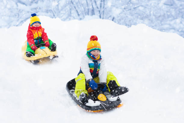 istock Boy on sled ride. Child sledding. Kid on sledge 1068861614