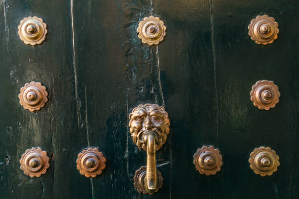 istock Wooden dark door with iron rivets background 1068861936